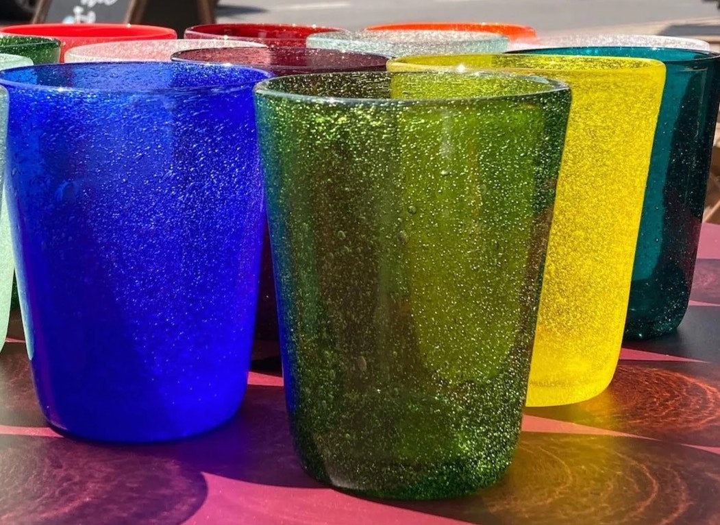Memento Coloured Water Glasses with sunlight shining through them highlighting the bubbles in each glass.  Dishwasher Safe Drinking Glasses