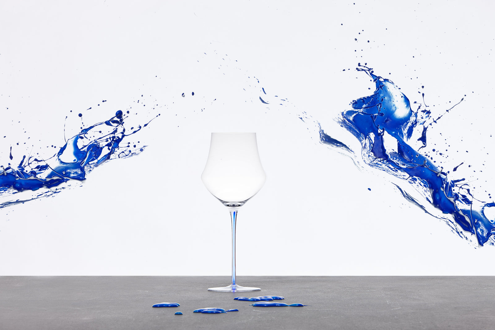 Memento handmade crystal wine glasses with colourful stems, designed in Italy.