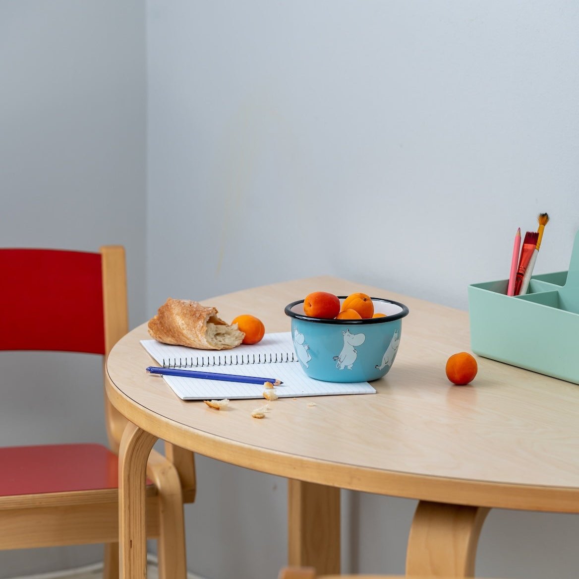 Muurla Moomintroll Enamel Bowl 0.6L, filled with sweets and biscuits. 
