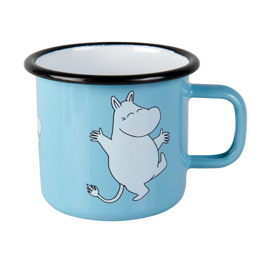 Moomin Enamel Retro Mug in Blue.  Moomintroll Design. Shown on a table with a Moomin enamel bowl and writing pad and pencil