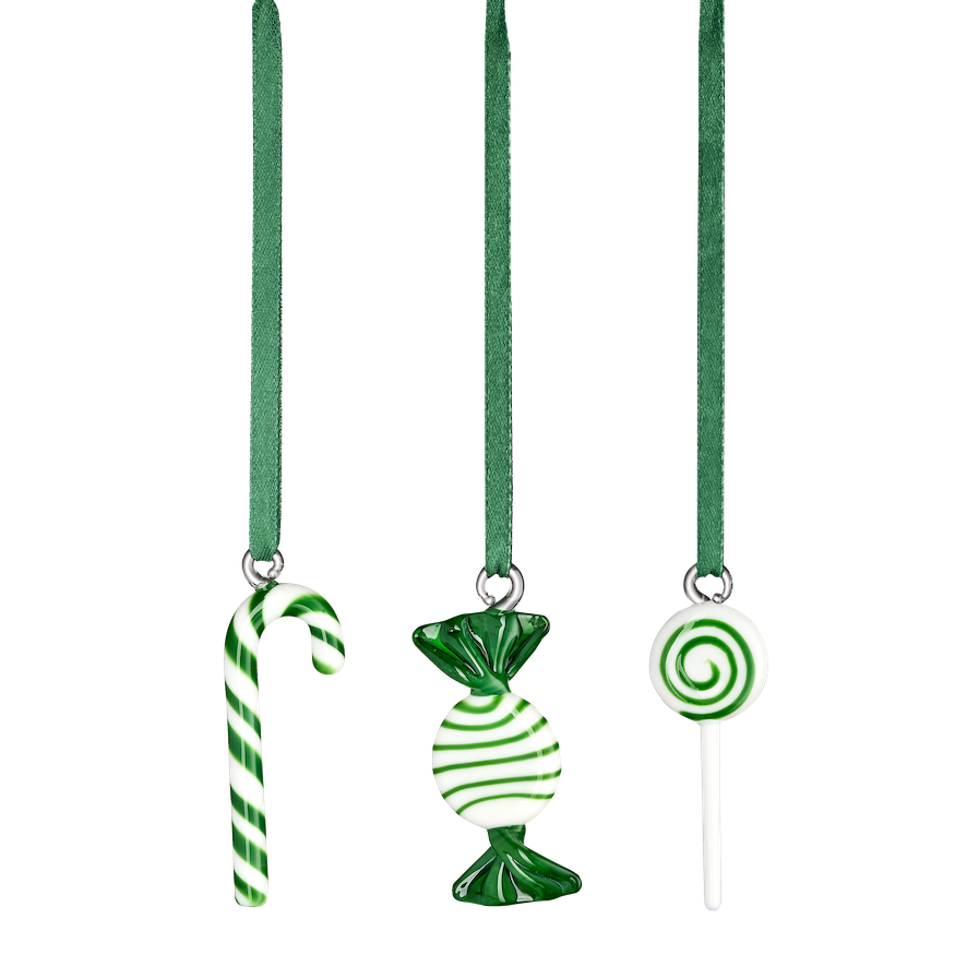 Gifts wrapped in brown paper with green ribbons and pine branches on a white fur surface.