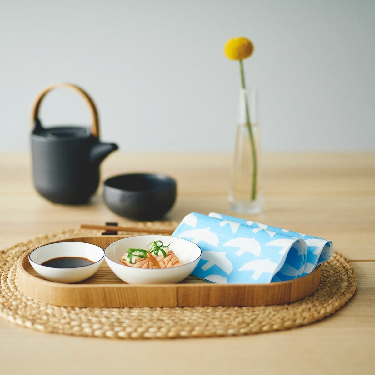 Folded Havi Paper Napkins in a blue and white bird design.  Set on a tray