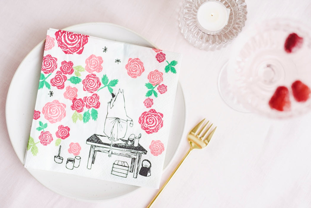 RoseMamma Moomin Paper Napkins on a white plate next to a gold cake fork 