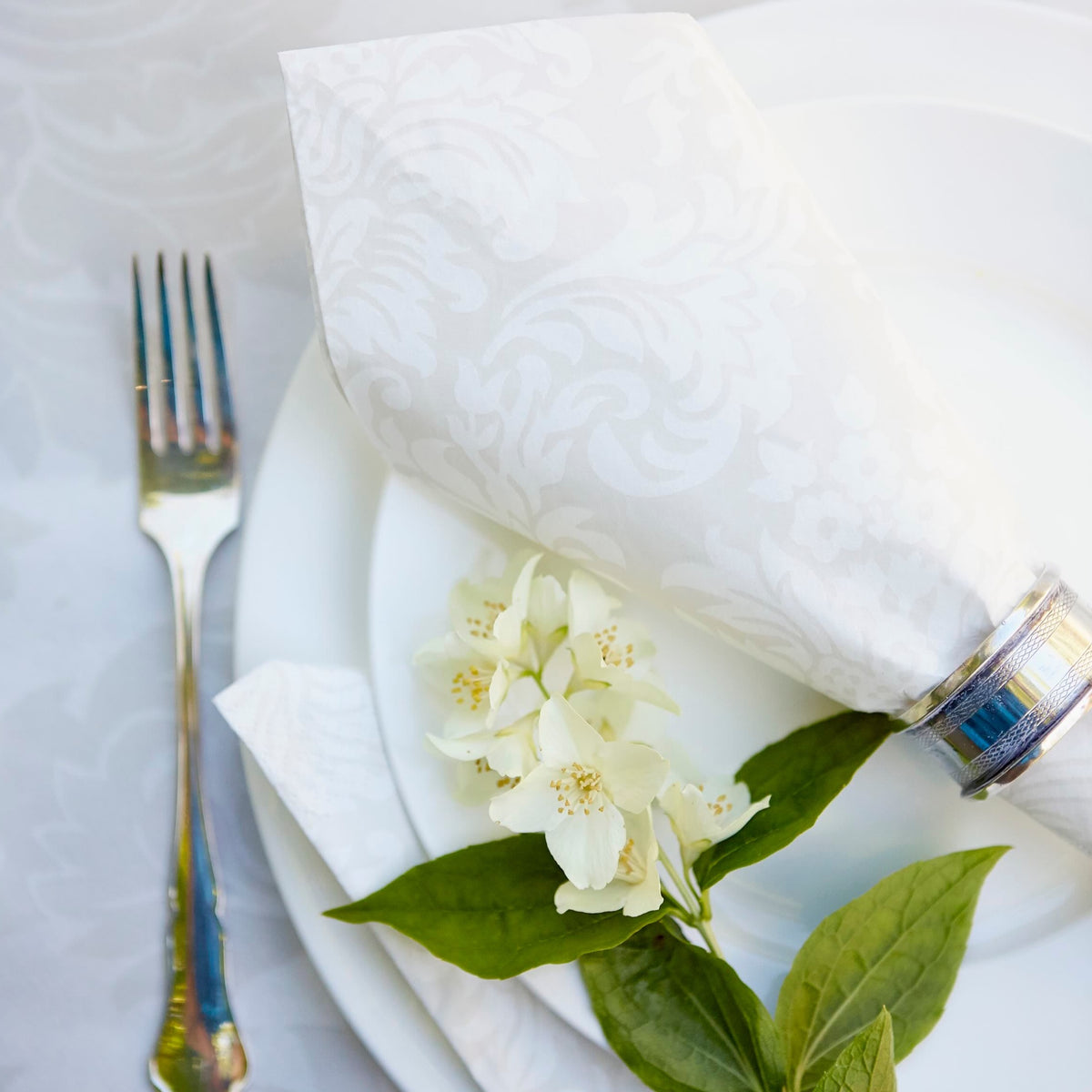 Havi Victoria Paper Napkins on a wedding table setting with a napkin ring and silver cutlery and flowers