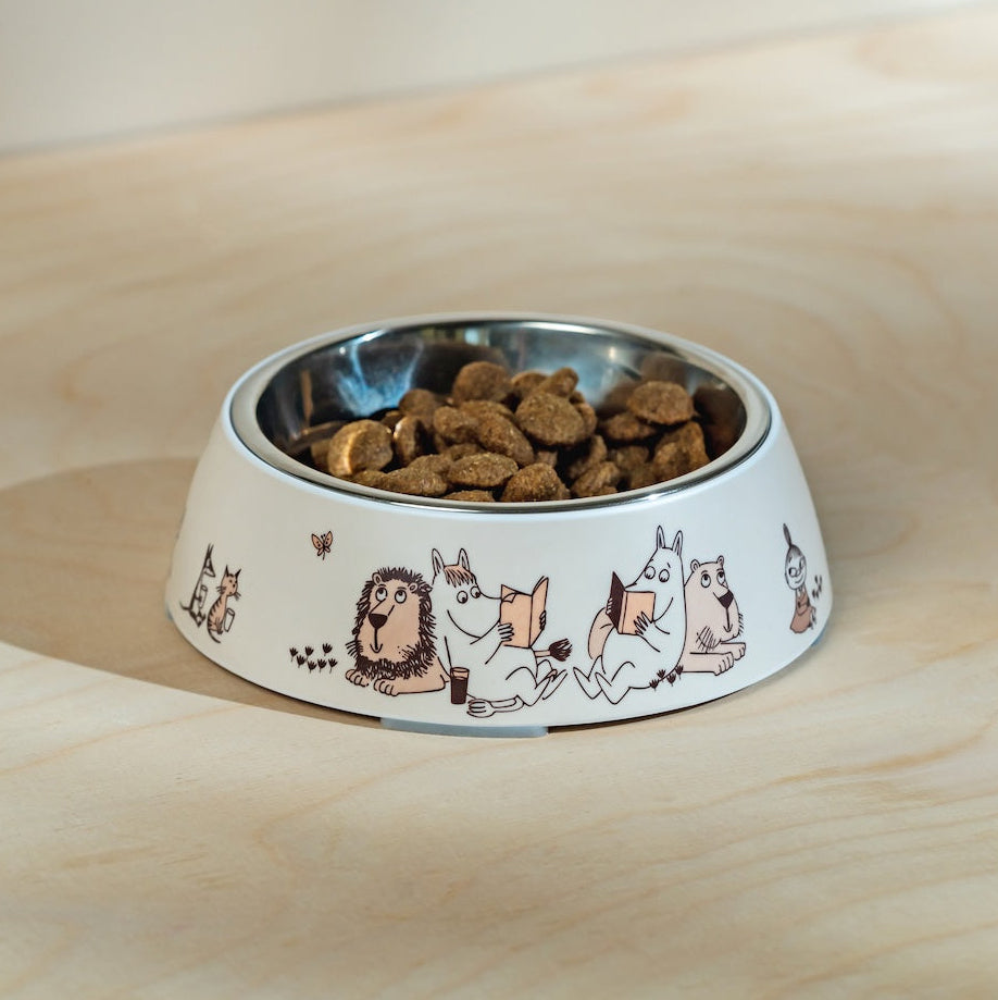 Dog bowl with Moomin characters on a wooden surface
