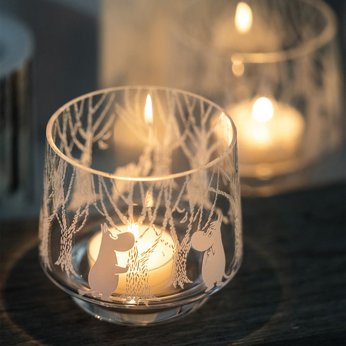 Moomin In the woods tea-light holder / small bowl, with a lit tea- light in side producing a soft glow of light through the decor.  Made by Muurla Design