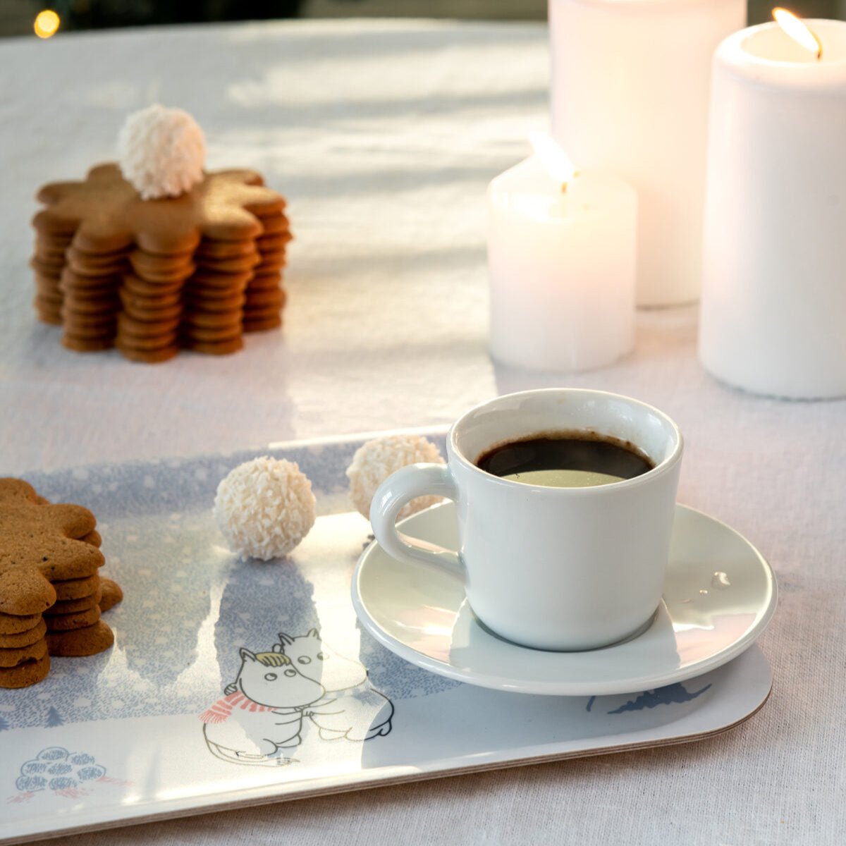 Muurla Moomin Let It Snow Tray in a Christmas Setting, with coffee and sweet treats.