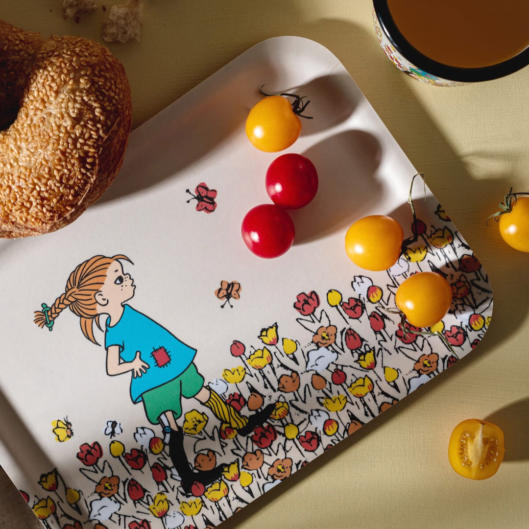 Be More Pippi Tray covered in tomatoes and next to a loaf of bread. Pippi Longstocking by Muurla Design