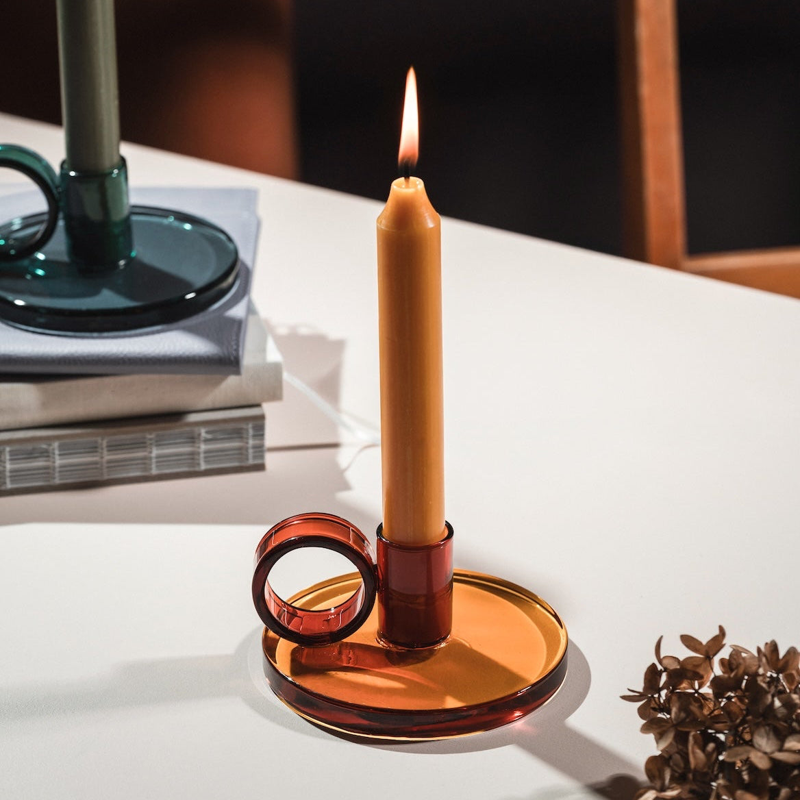 Loop Candle holder in Amber on a white surface with a blurred background