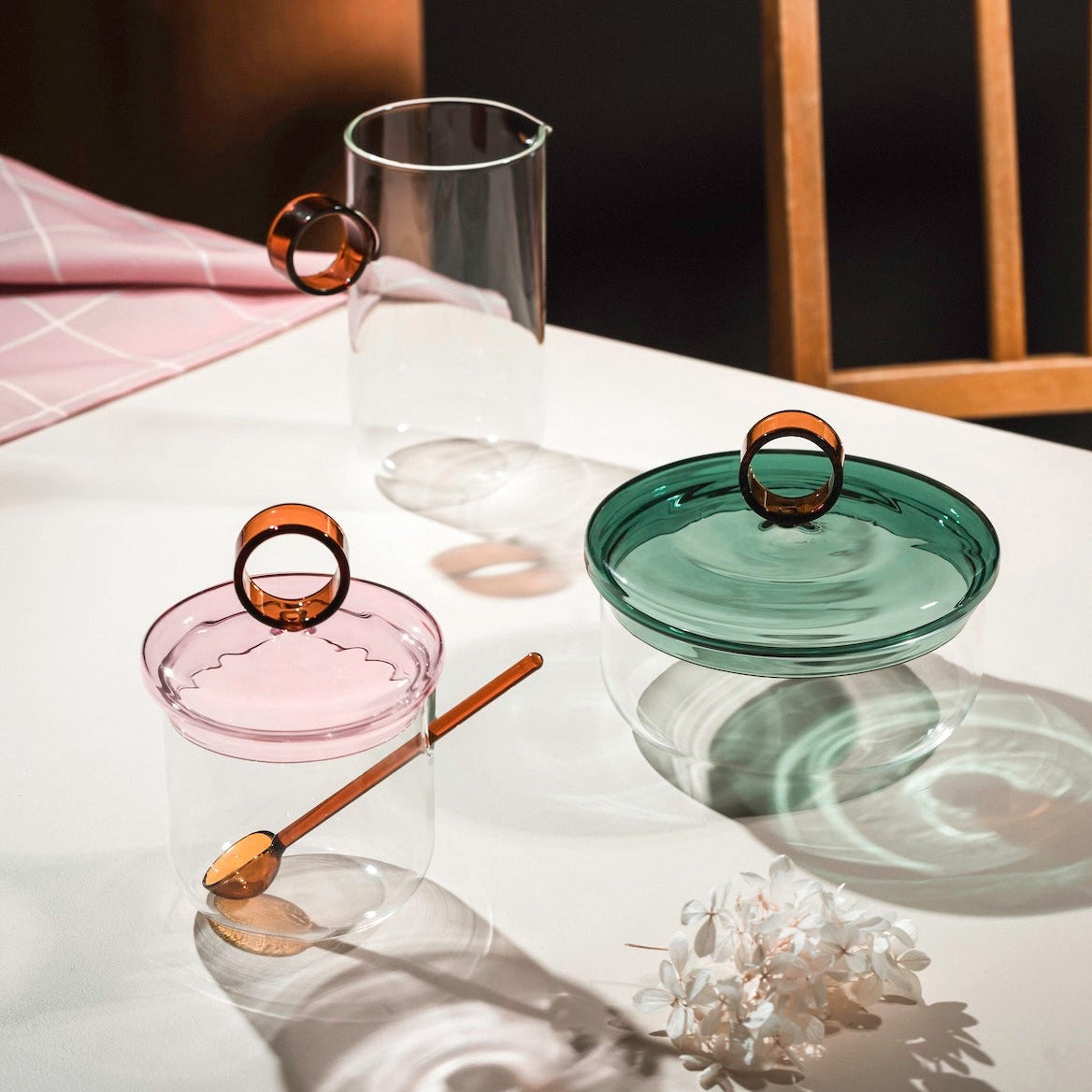 Set of Loop glass containers by Muurla Design on a white surface with a dark background