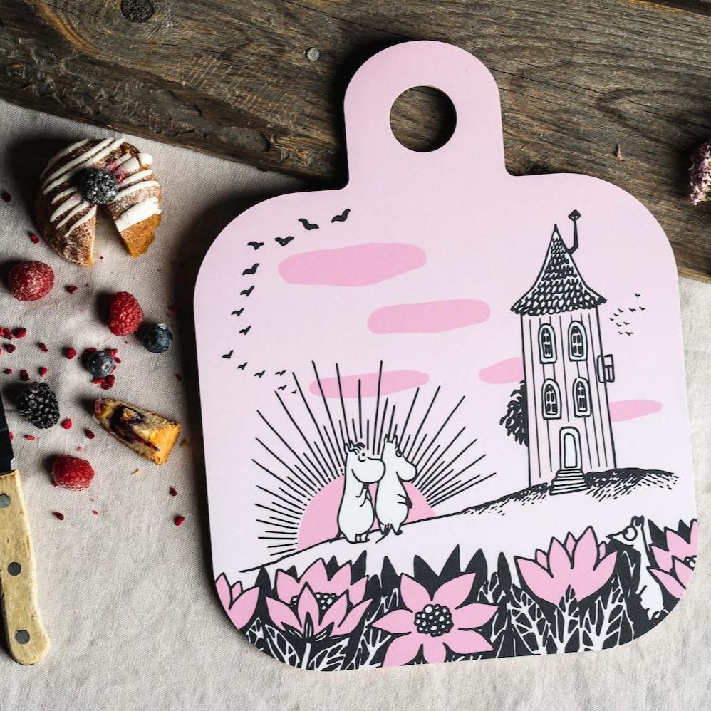 Pink Moomin Chop and Serve boards next to a cake and berries