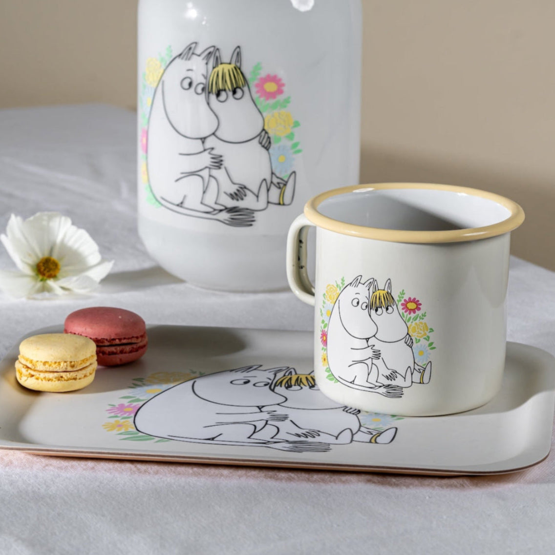 Muurla Moomin Flowers Larger Mug shown on a tray and next to a vase with the same Flowers design