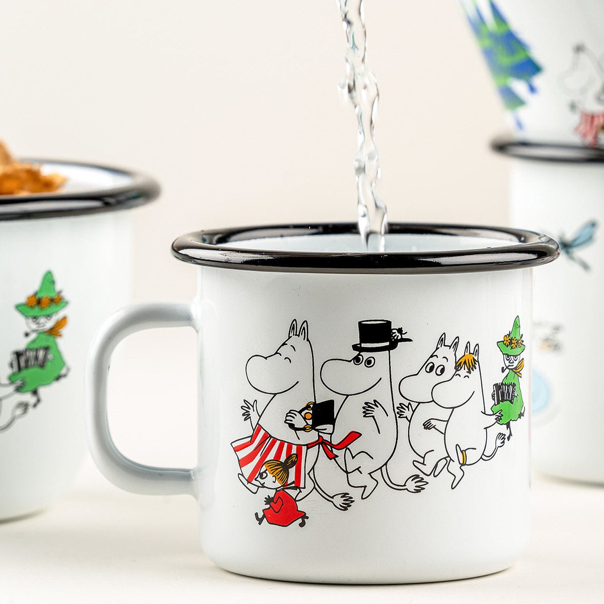 Moomin Valley Colours Design by Muurla. Enamel Mugs and Bowls in a the classic white Moomin Valley design