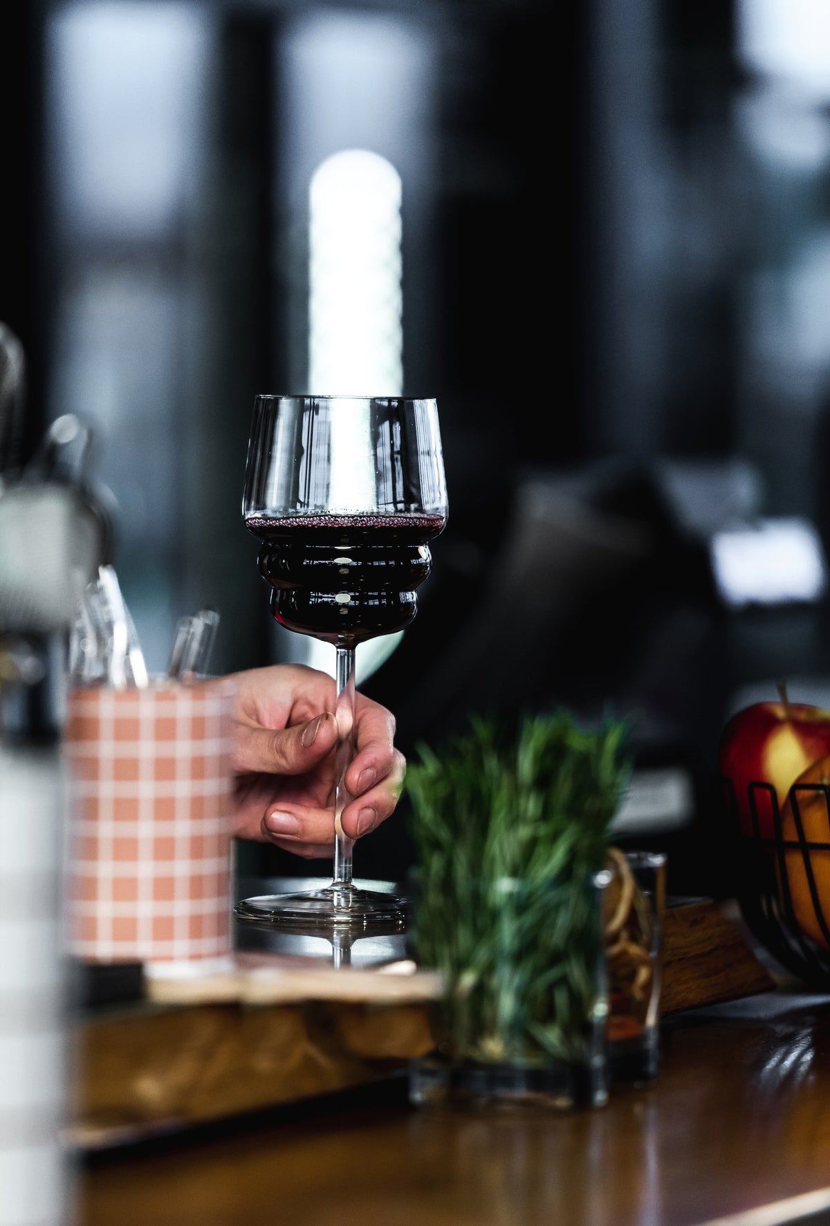 Muurla Design Red Wine Glass being held in a hand