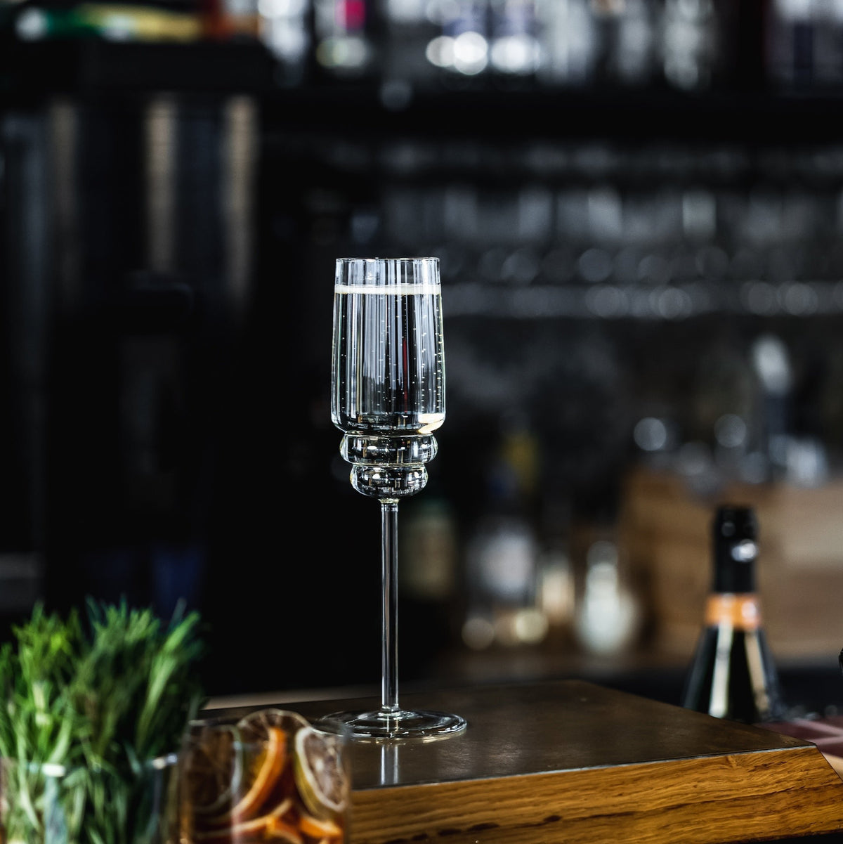 A full Steps Champagne Glass on a bar, design by Muurla Design. 