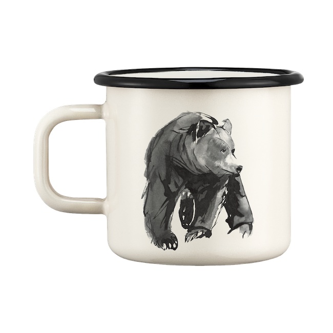 Teemu Jarvi Bear Enamel Mug by Muurla, on a table next to an open book.