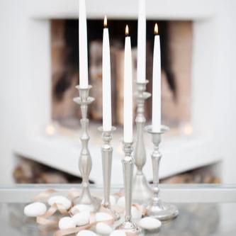 Havi Antique Tapered Dinner Candles shown in silver candelabras.    Candles made in Finland since 1829