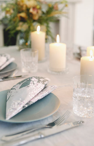 Havi Syysmuutto dinner napkins on a det dinne r table with plates, cutlery and candles