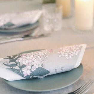 Havi Pink and Grey Napkins on a grey dinner plate, on a set table