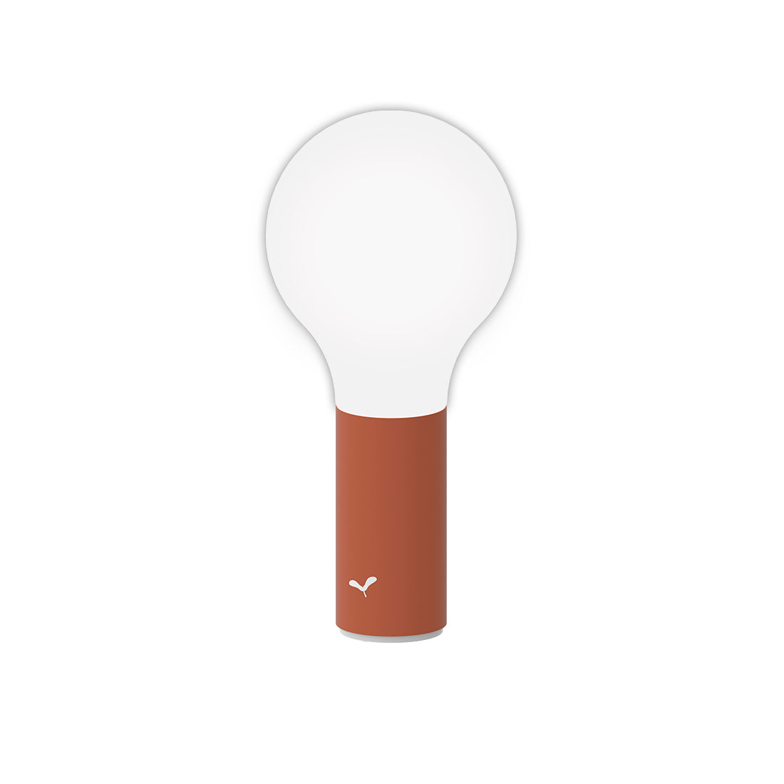 Fermob Aplô portable indoor and outdoor Lamp in Red Ochre in front of a white background. 