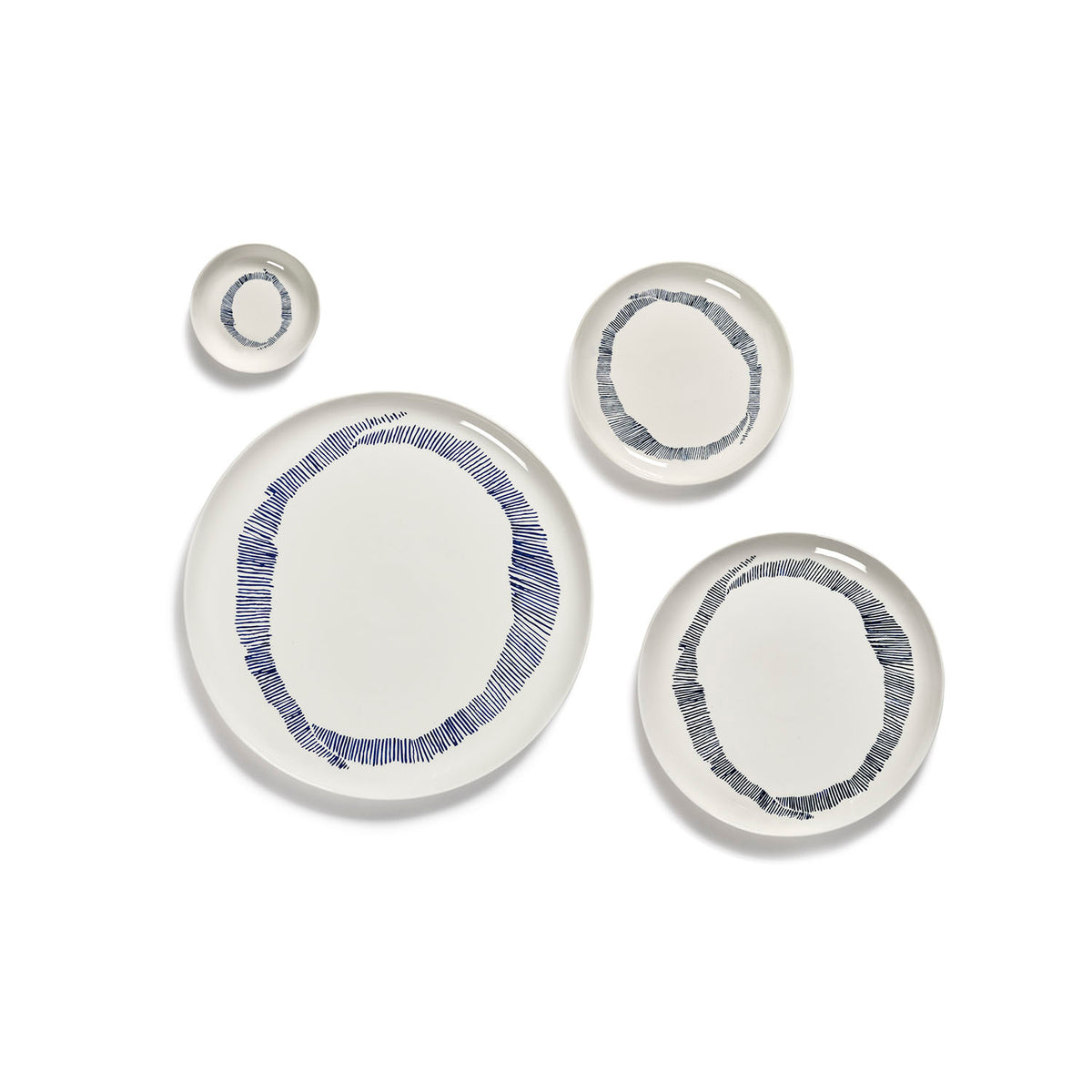 Ottolenghi for Serax Feast collection, group picture of separated tableware including small dish, with white swirl and blue stripes design.