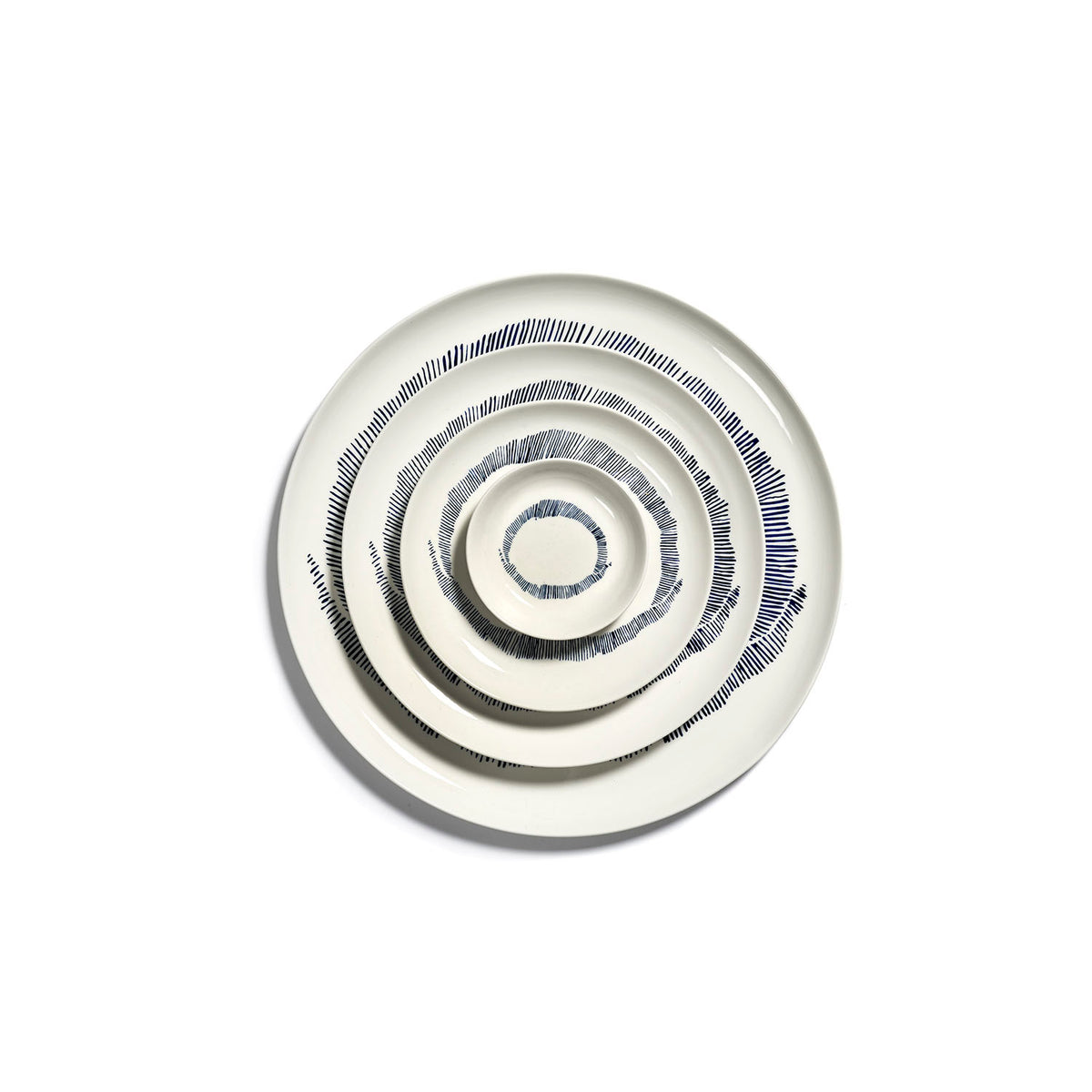Ottolenghi for Serax Feast collection, group picture of tableware including small dish, with white swirl and blue stripes design.
