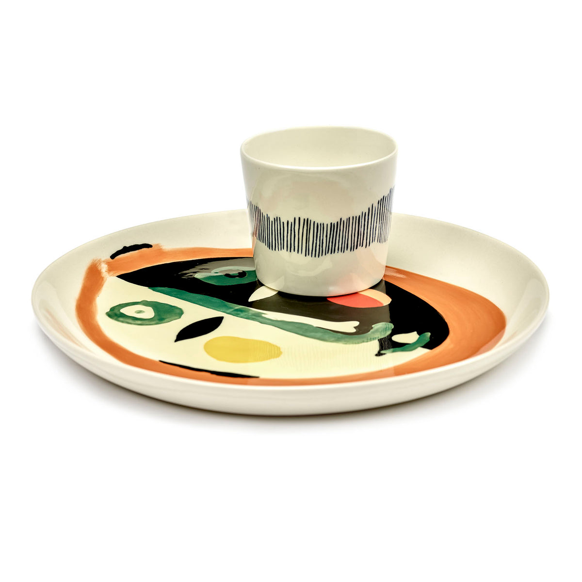 Ottolenghi for Serax Feast collection, side view of medium plate with face design and small cup, plates available in four sizes and mixed designs.