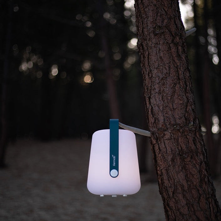 Fermob Balad Lamp in Acapulco Blue hanging on a tree