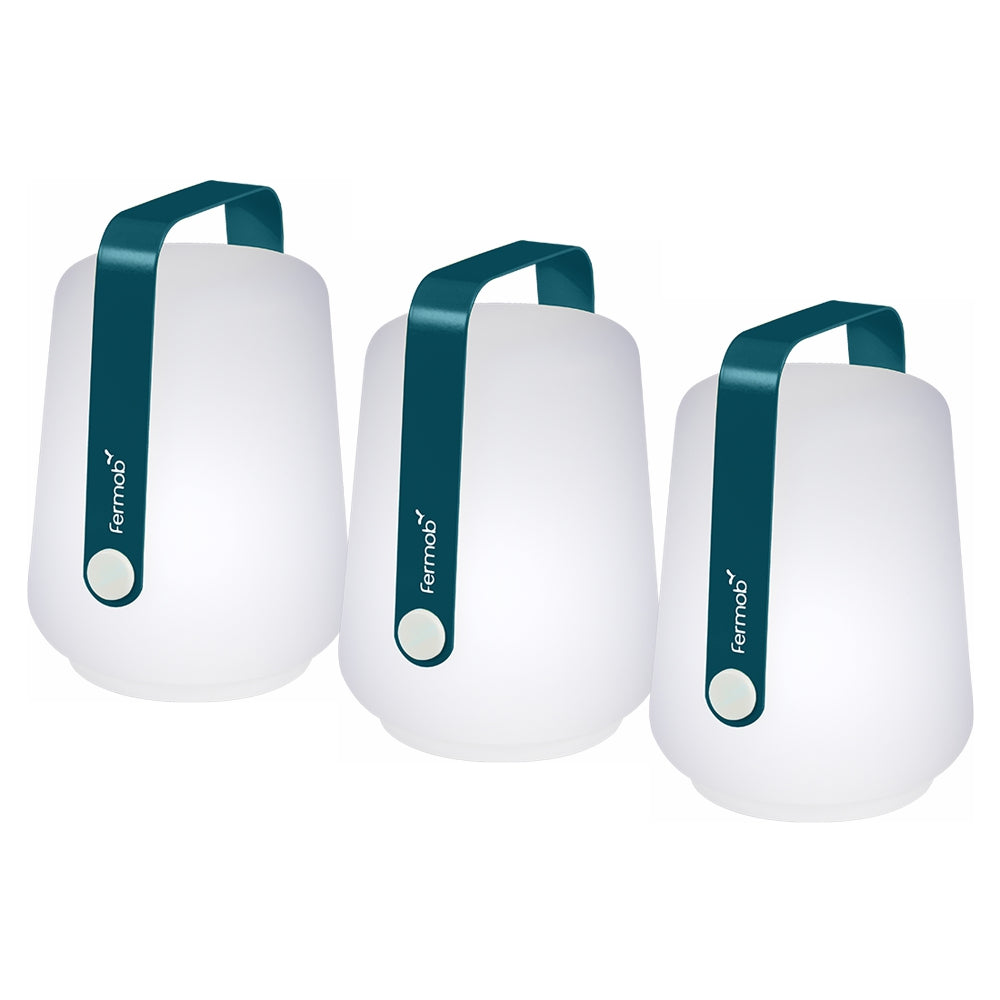 3 Fermob lanterns in Acapulco Blue on a White background. The lanterns have the Fermob logo on their metal handles.