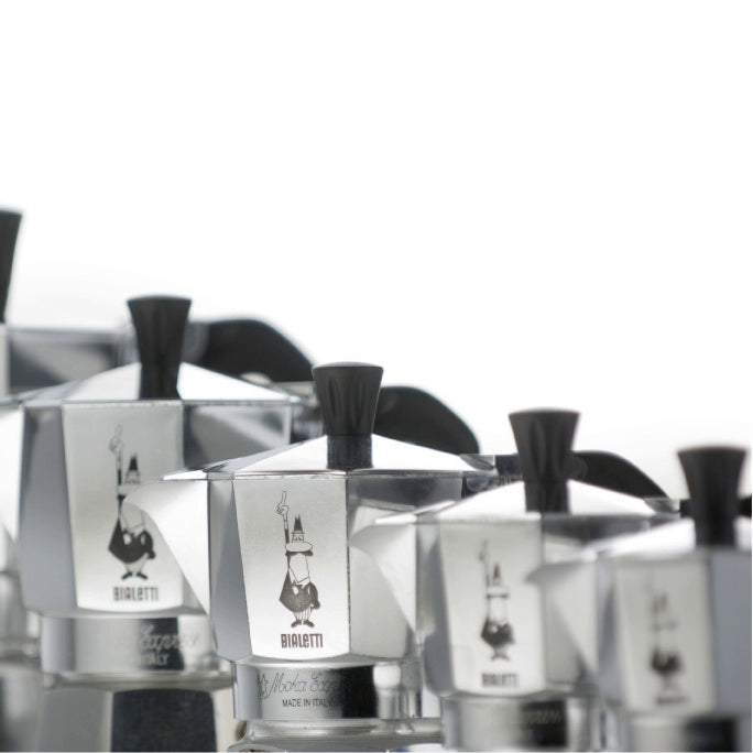 Line of Bialetti Moka Express stovetop Coffee makers in size order.