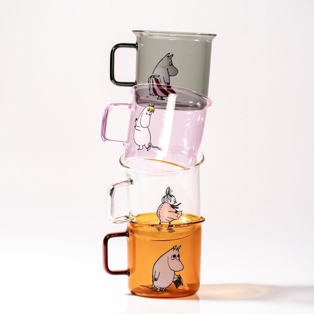 A stack of glass Moomin mugs by Muurla from Finland