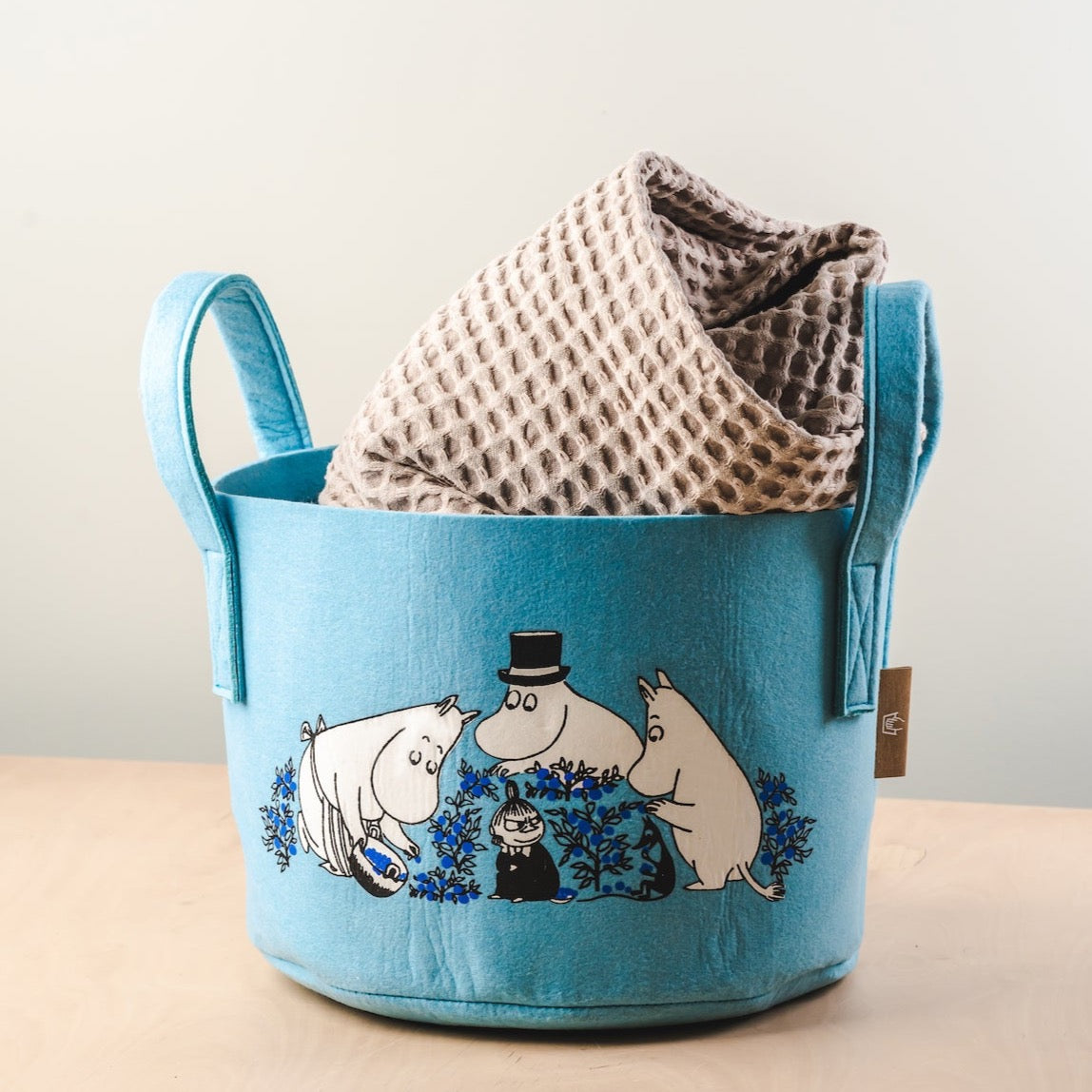 A blanket stored in a Muurla Design Blueberries Storage Basket 