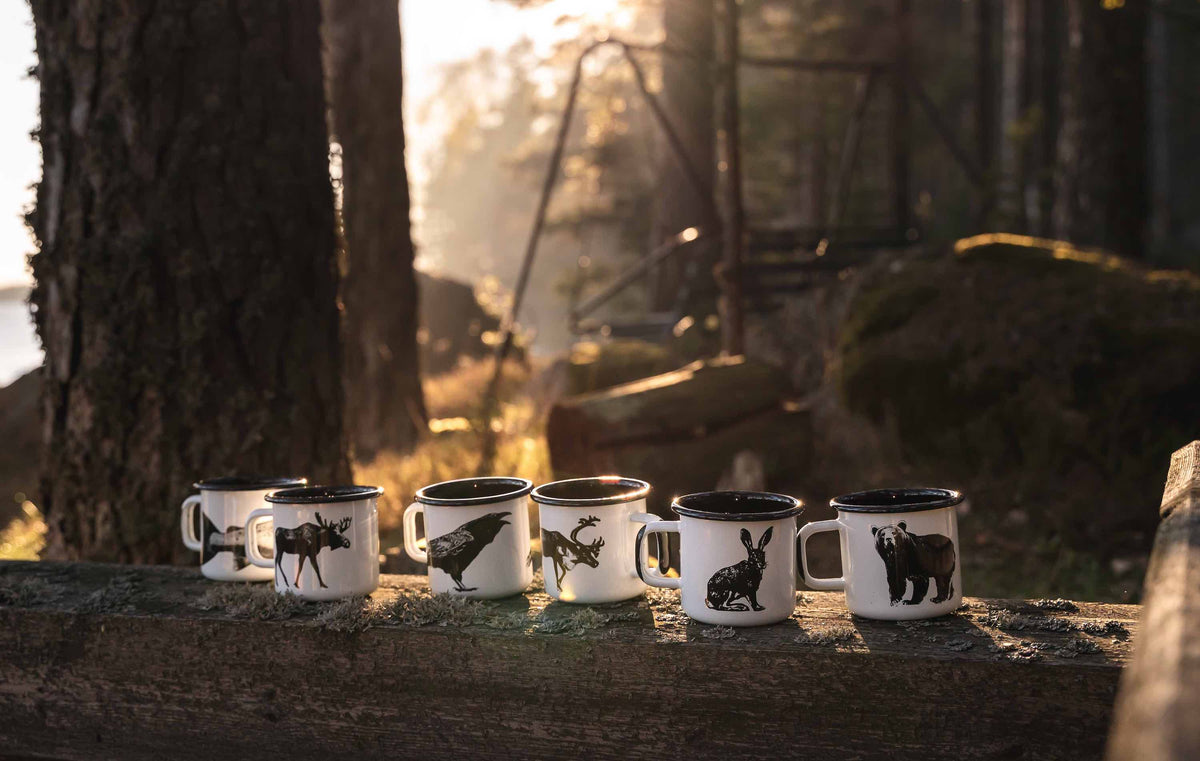 Muurla Design Nordic Mugs lined up on a fallen tree branch