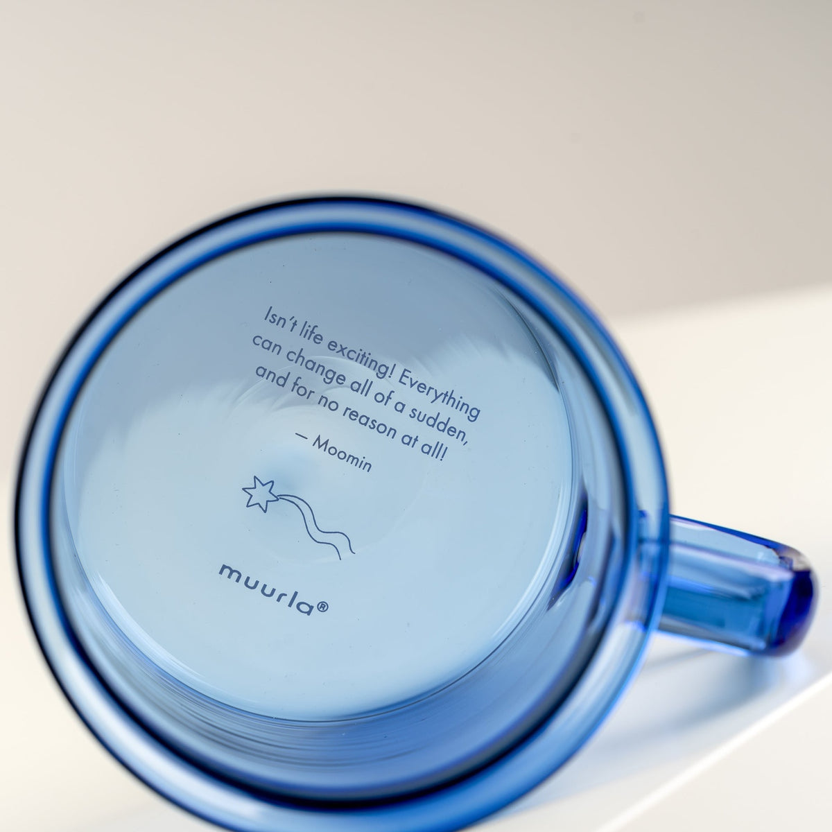 text on the bottom of a Moomin glass mug by Muurla Design