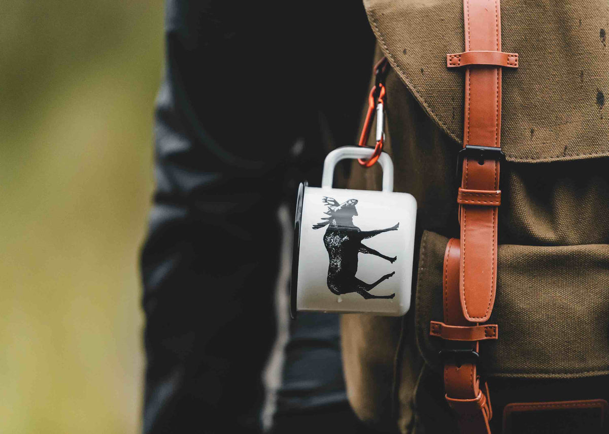 Enamel mug By Muurla Hanging on a rucksack