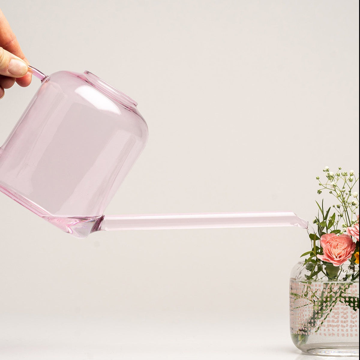 Water being poured from a Muurla Design Pink Watering Can 0.8L