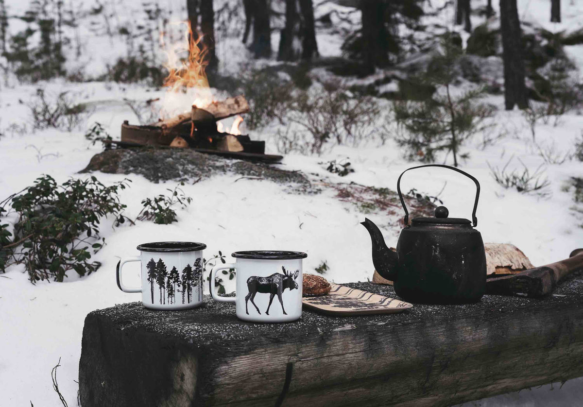 Muurla Design Nordic Enamel Mugs next to a teapot 