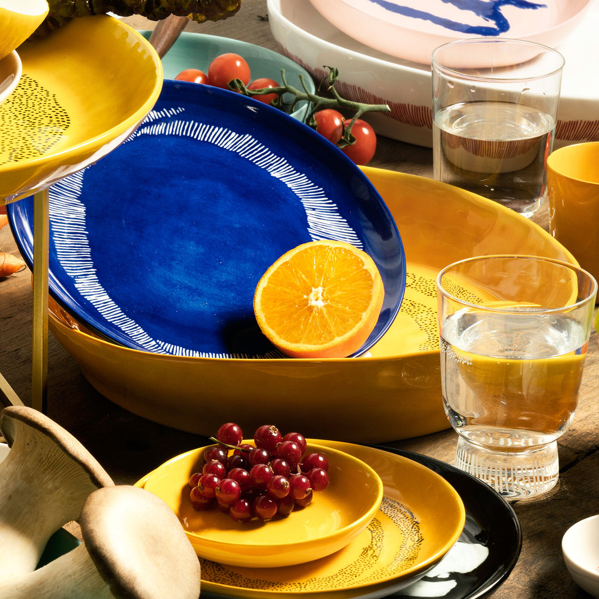 Ottolenghi for Serax Feast collection, group of plates, amongst bowls, glasses and tableware.