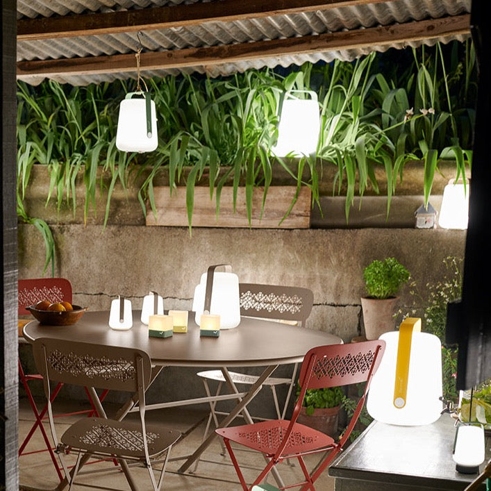 Fermob Balad Lamps in various sizes in a summer outdoor area